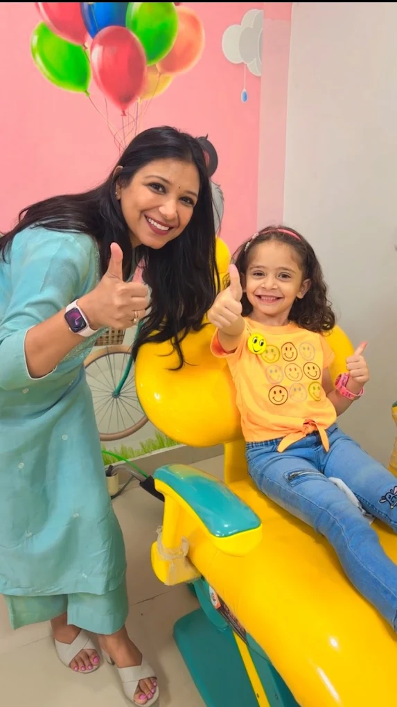 Dr. Anukriti Gupta with a happy young patient in the dental chair