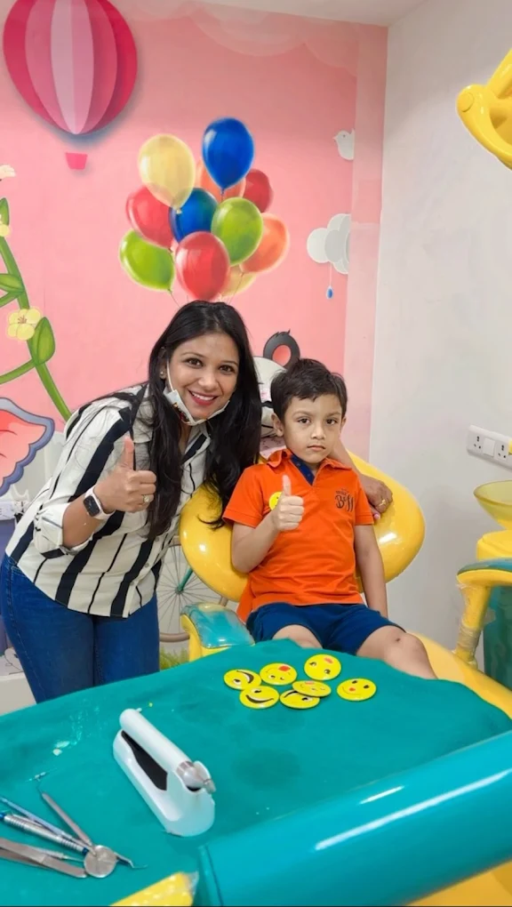 Dr. Anukriti Gupta with a young patient in the dental chair